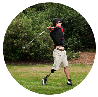 man swinging golf club with a prosthetic leg